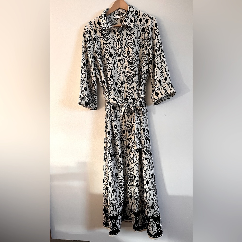 Black and cream shirt-style dress with buttons along the entire length.
